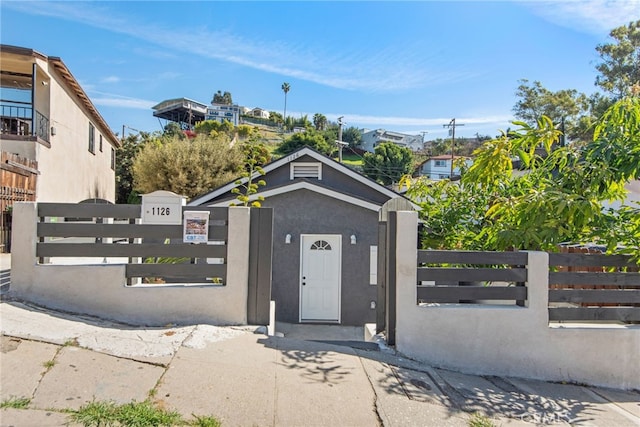 view of gate with a fenced front yard