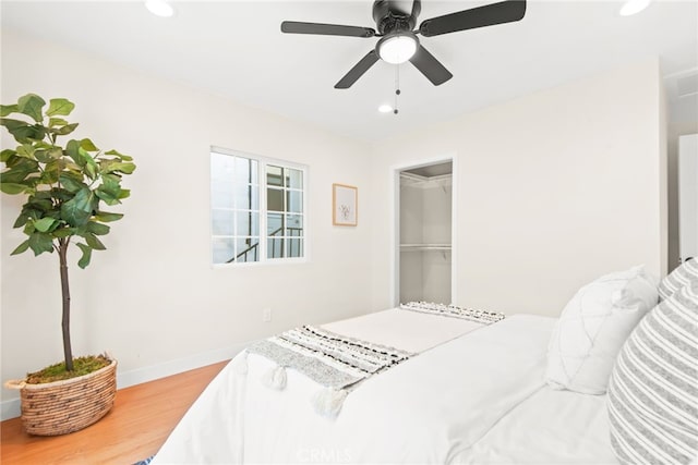 bedroom with baseboards, wood finished floors, a ceiling fan, and recessed lighting