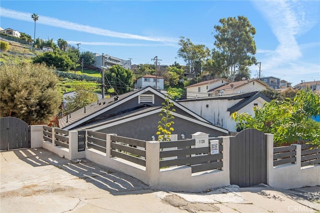 view of front of property with a fenced front yard and a gate