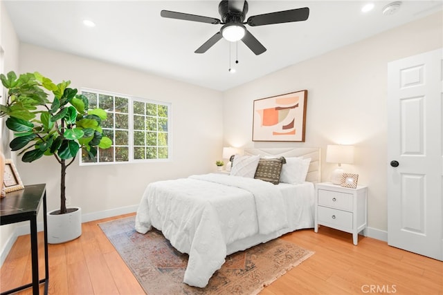 bedroom featuring recessed lighting, wood finished floors, a ceiling fan, and baseboards