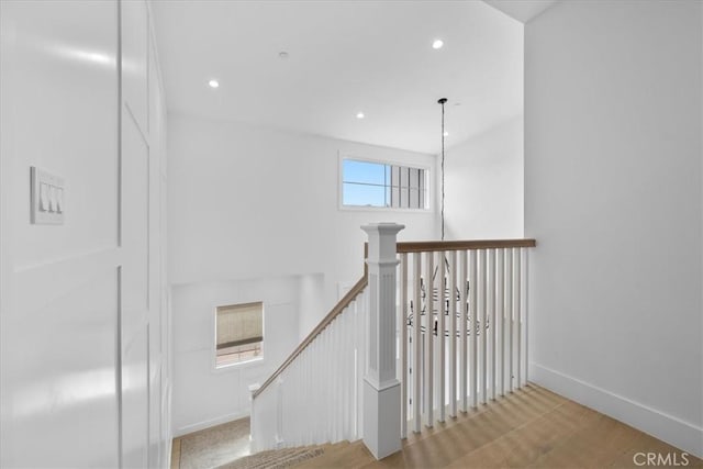 staircase with recessed lighting, baseboards, and wood finished floors