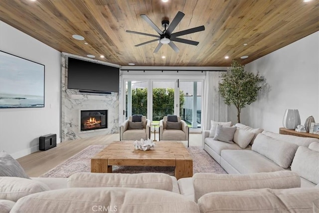 living room featuring wooden ceiling, recessed lighting, a ceiling fan, and a high end fireplace