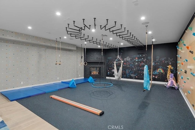 exercise area with a warm lit fireplace