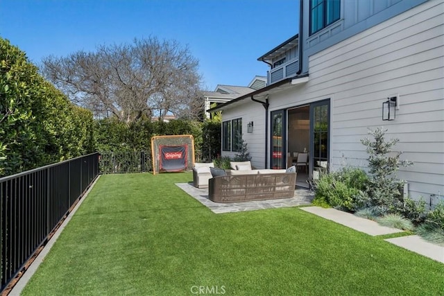 view of yard featuring a patio area, an outdoor living space, and a fenced backyard