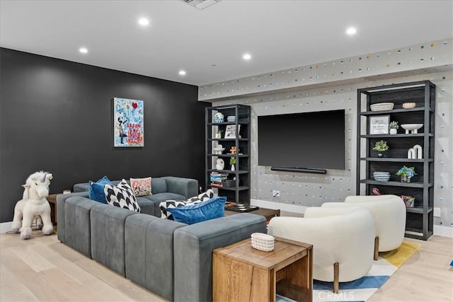 living area with recessed lighting, light wood-type flooring, baseboards, and visible vents