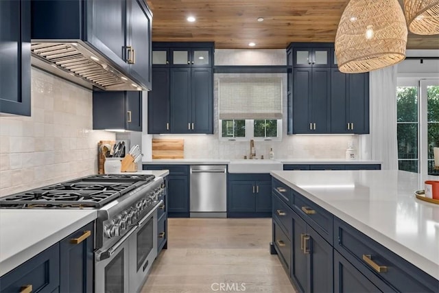 kitchen with blue cabinetry, wooden ceiling, stainless steel appliances, and light countertops