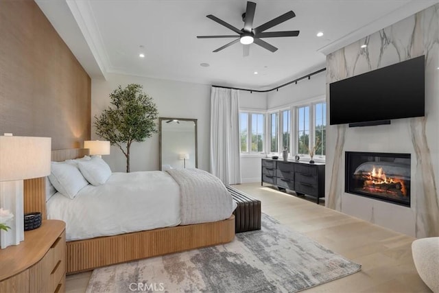 bedroom featuring recessed lighting, a large fireplace, and a ceiling fan