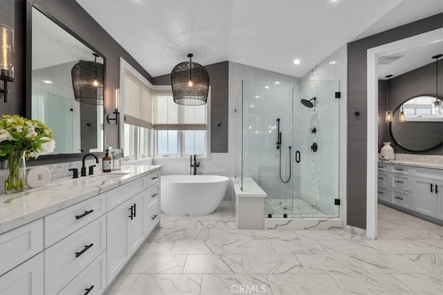 full bathroom with marble finish floor, a stall shower, vanity, and vaulted ceiling