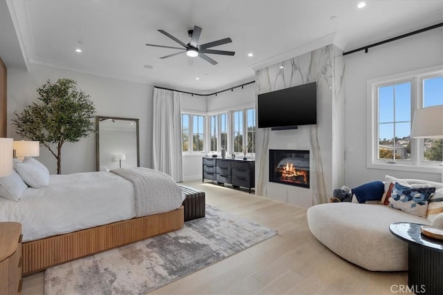 bedroom featuring recessed lighting, a fireplace, ceiling fan, and wood finished floors