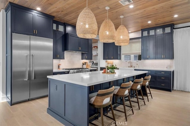 kitchen featuring stainless steel built in refrigerator, blue cabinetry, a center island, light countertops, and wood ceiling