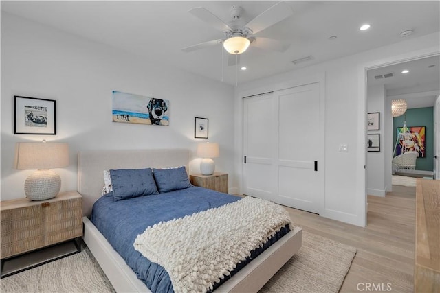 bedroom featuring visible vents, recessed lighting, ceiling fan, a closet, and light wood-type flooring