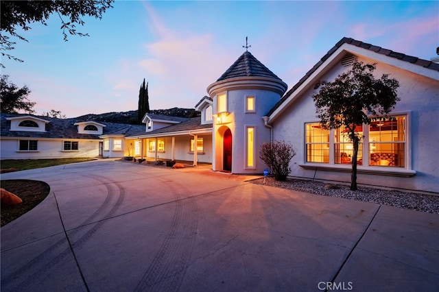 view of front of house featuring concrete driveway and stucco siding