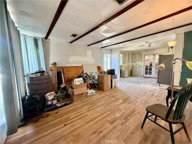 interior space featuring beam ceiling and wood finished floors