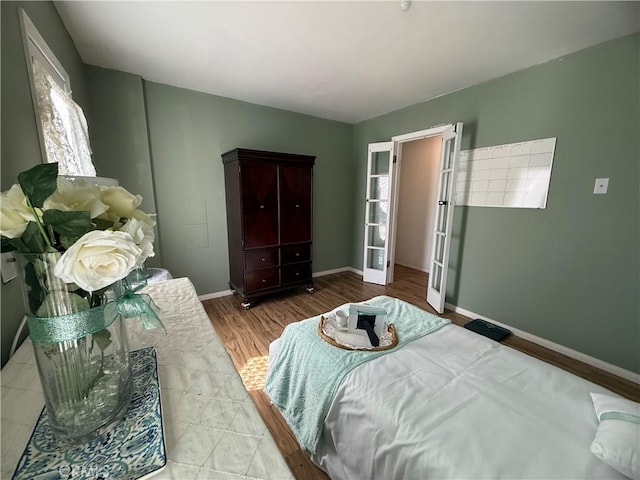 bedroom with baseboards and wood finished floors