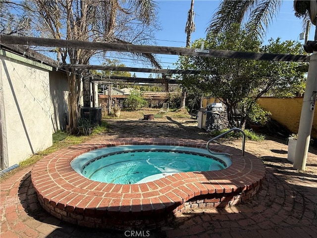 view of pool featuring an in ground hot tub, central AC unit, and fence