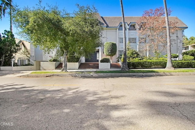 view of front of home with a tiled roof and stucco siding