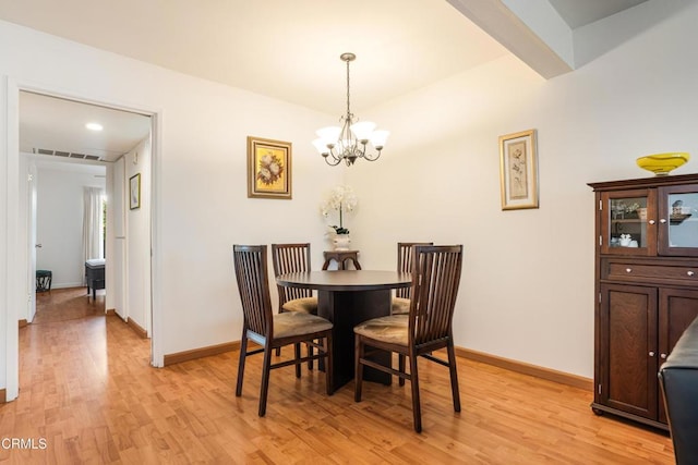 dining area with visible vents, baseboards, a chandelier, and light wood finished floors