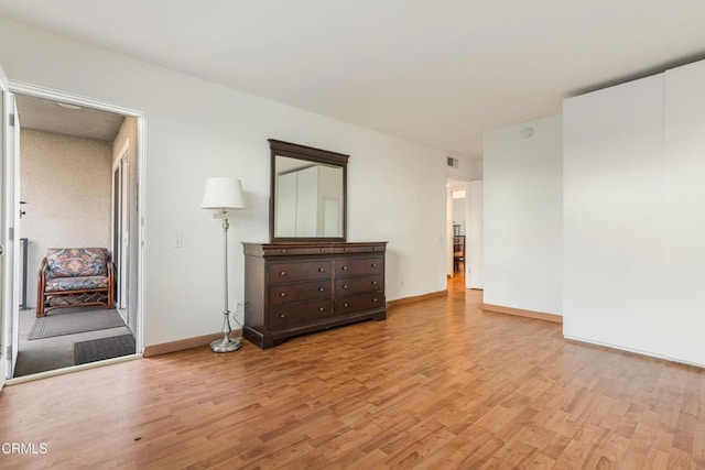 unfurnished bedroom featuring baseboards and light wood-type flooring