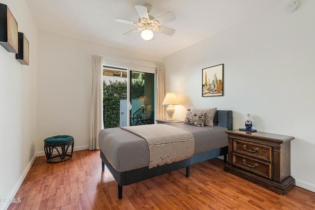 bedroom with access to outside, baseboards, light wood finished floors, and ceiling fan