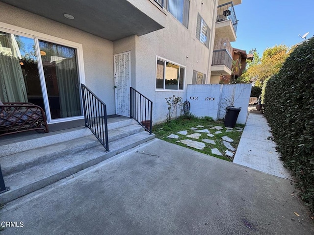 exterior space featuring entry steps and fence