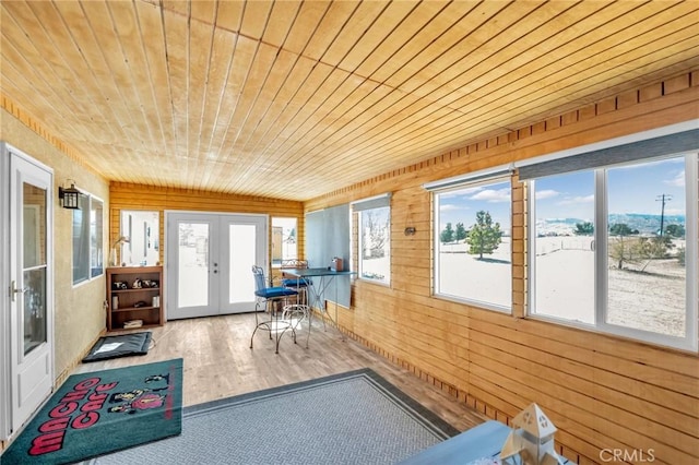 sunroom / solarium featuring french doors and wood ceiling