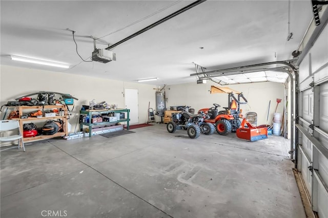 garage with a garage door opener and strapped water heater