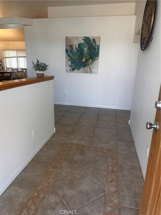 interior space featuring tile patterned floors and baseboards