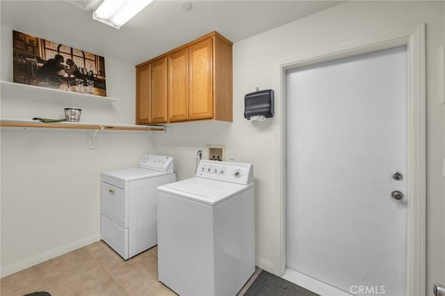 laundry room with cabinet space, baseboards, and separate washer and dryer