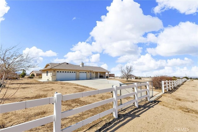 view of front of home featuring a fenced front yard, driveway, and an attached garage