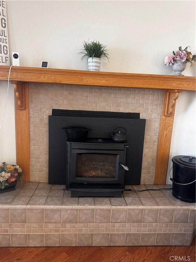 details featuring wood finished floors and a wood stove