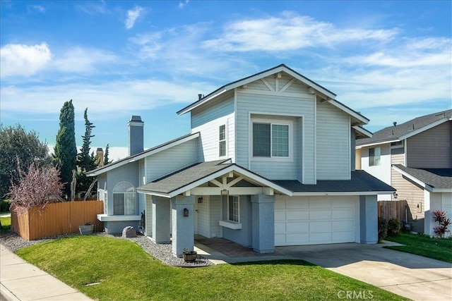 traditional home featuring a garage, driveway, a front lawn, and fence