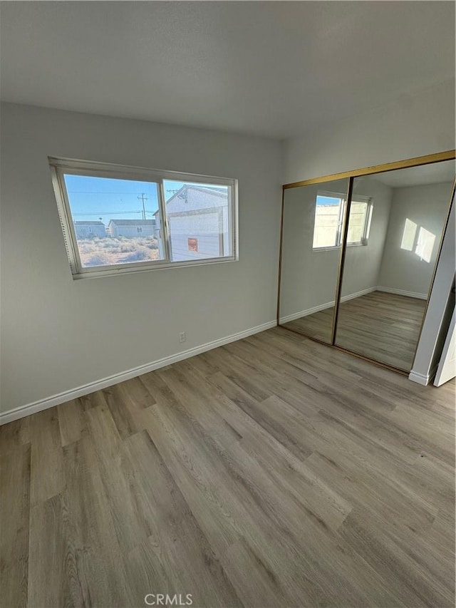 13063 Gilbert St, Edwards, CA 93523 - unfurnished bedroom with wood finished floors and a closet