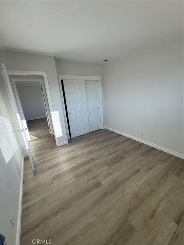 13063 Gilbert St, Edwards, CA 93523 - unfurnished bedroom featuring wood finished floors and a closet
