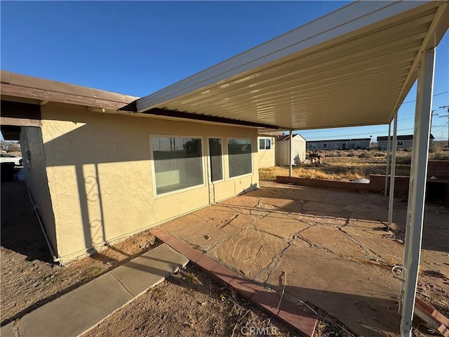 view of patio with a storage shed and an outdoor structure