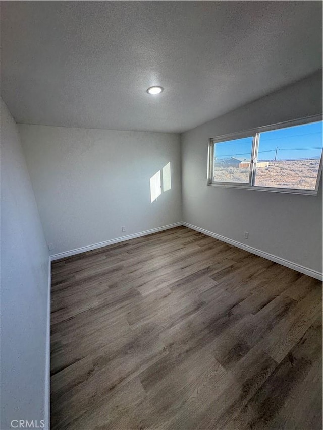 13063 Gilbert St, Edwards, CA 93523 - empty room with a textured ceiling, wood finished floors, and recessed lighting