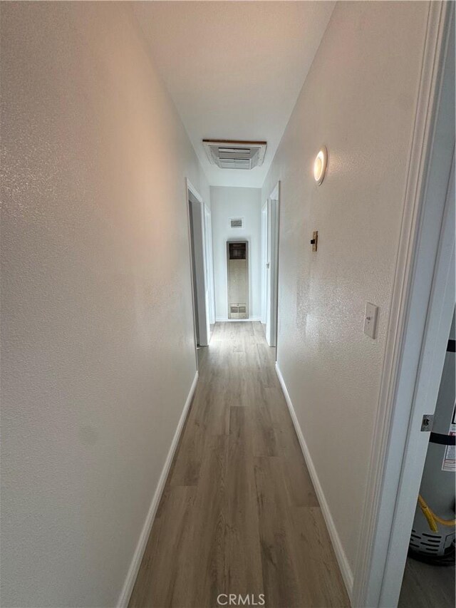 13063 Gilbert St, Edwards, CA 93523 - hallway featuring wood finished floors and baseboards
