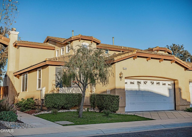 mediterranean / spanish-style home featuring driveway, a tile roof, a garage, and stucco siding