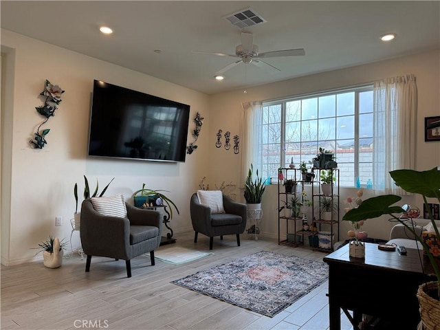 living room with light wood-type flooring, visible vents, recessed lighting, and a ceiling fan