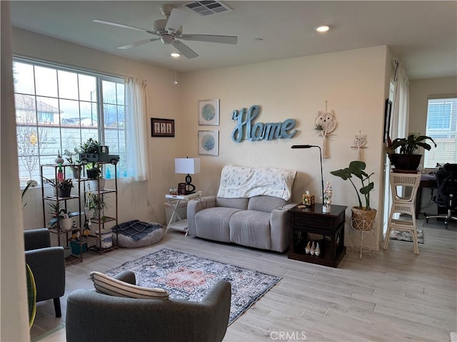 living area featuring ceiling fan, visible vents, wood finished floors, and recessed lighting