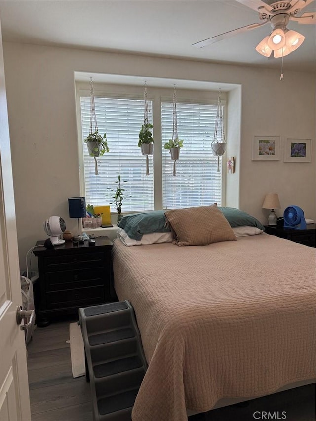 bedroom with a ceiling fan and wood finished floors