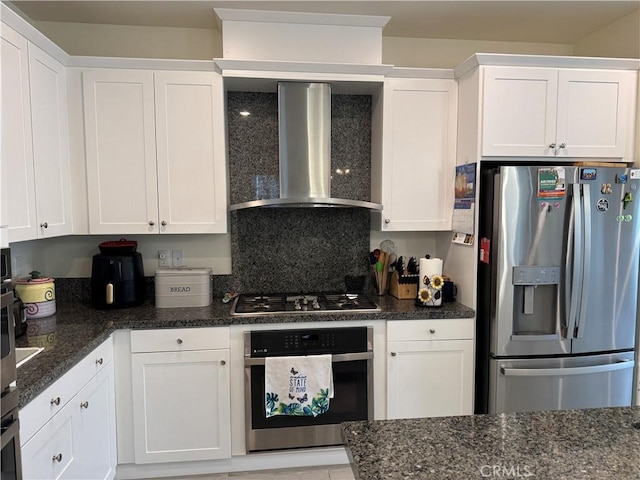 kitchen with white cabinetry, wall chimney exhaust hood, and appliances with stainless steel finishes