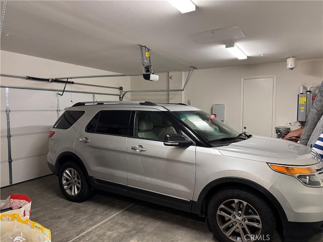 garage with a garage door opener and water heater