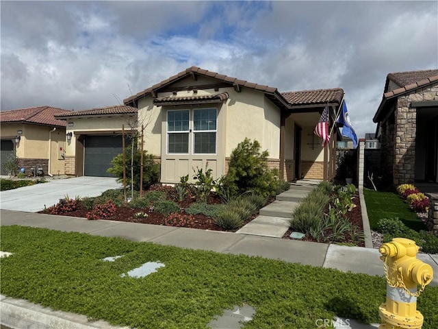 view of front facade with a tile roof, a garage, and stucco siding