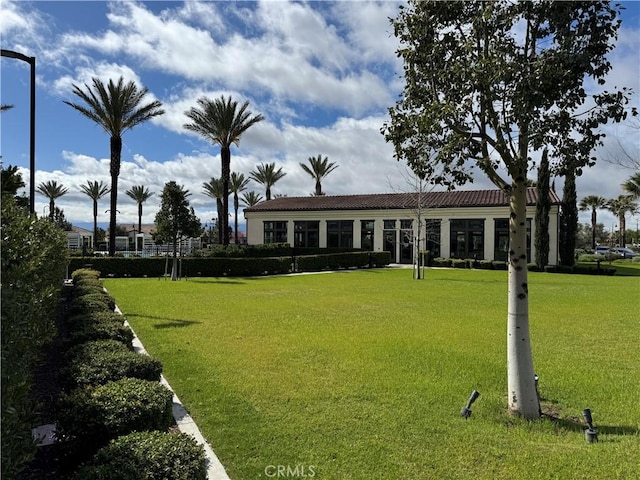 exterior space with a front yard and a tile roof