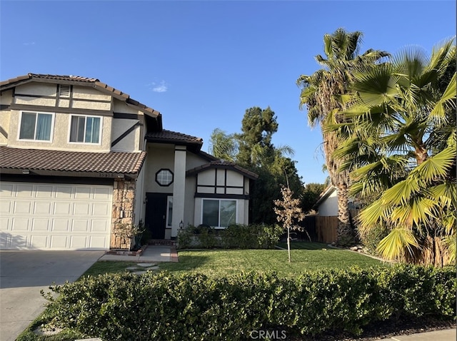 view of front of home featuring a front lawn, a tiled roof, stucco siding, stone siding, and driveway