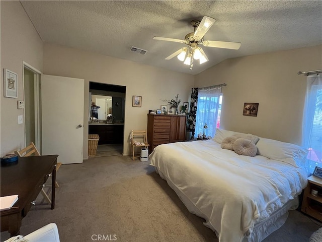 carpeted bedroom with ceiling fan, lofted ceiling, visible vents, and a textured ceiling