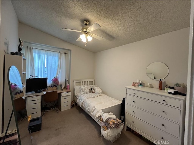 bedroom featuring dark colored carpet, lofted ceiling, a textured ceiling, and a ceiling fan