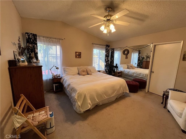 bedroom featuring vaulted ceiling, multiple windows, carpet, and a textured ceiling