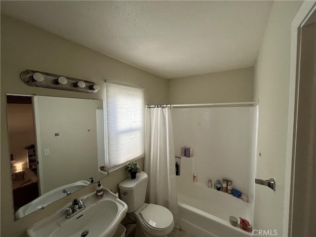 full bathroom featuring a sink, toilet, and shower / tub combo