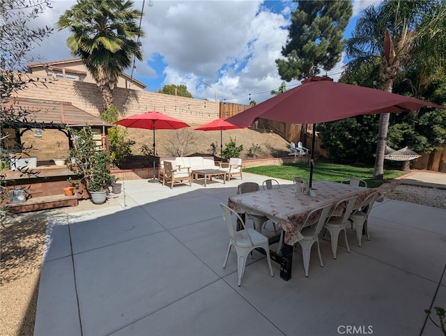 view of patio with a fenced backyard, outdoor lounge area, and outdoor dining space